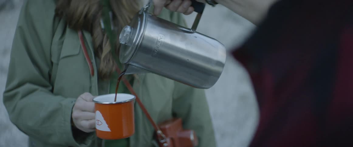 Someone is pouring coffee into someone else's cup