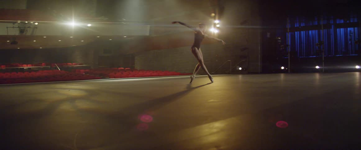 A ballerina dances on a stage