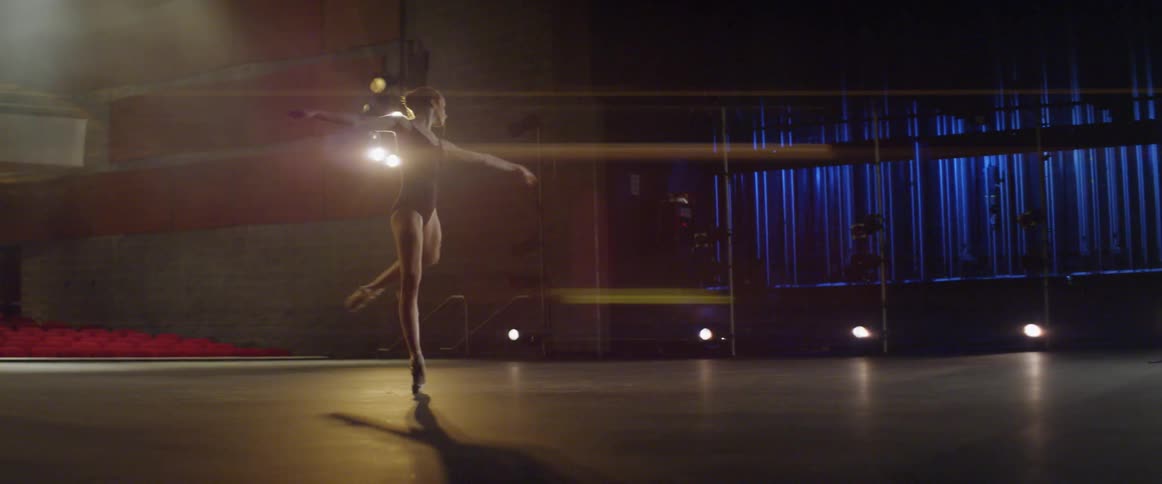 A ballet dancer is twirling on stage