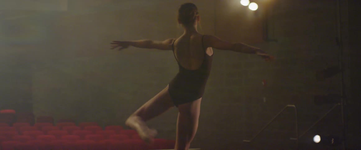 A woman dances on stage