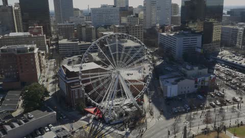 Aerial view of a city with a ferris wheel below