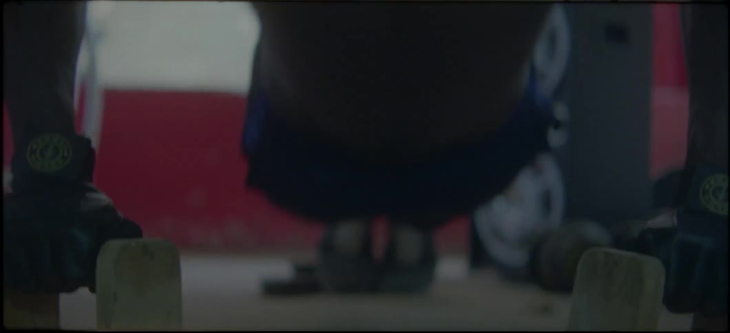 A man is doing push ups in the gym with elevated weights