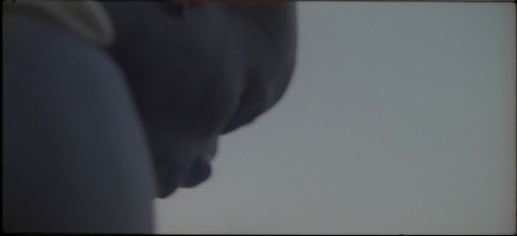 A man is looking down at something off screen