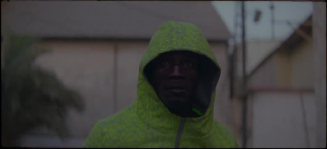 A man is jogging outside wearing a hoodie