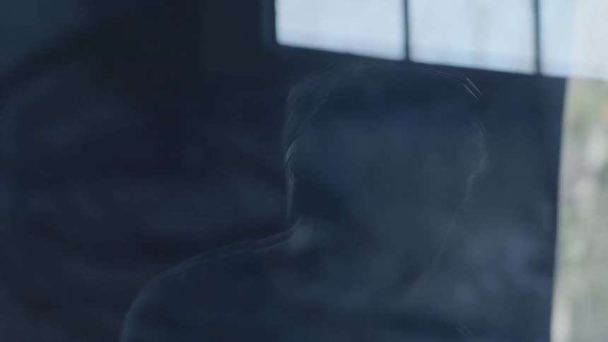A man nods while wearing headphones