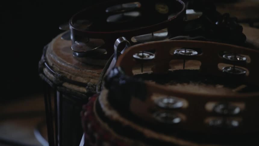 The drums sit in the dark area still