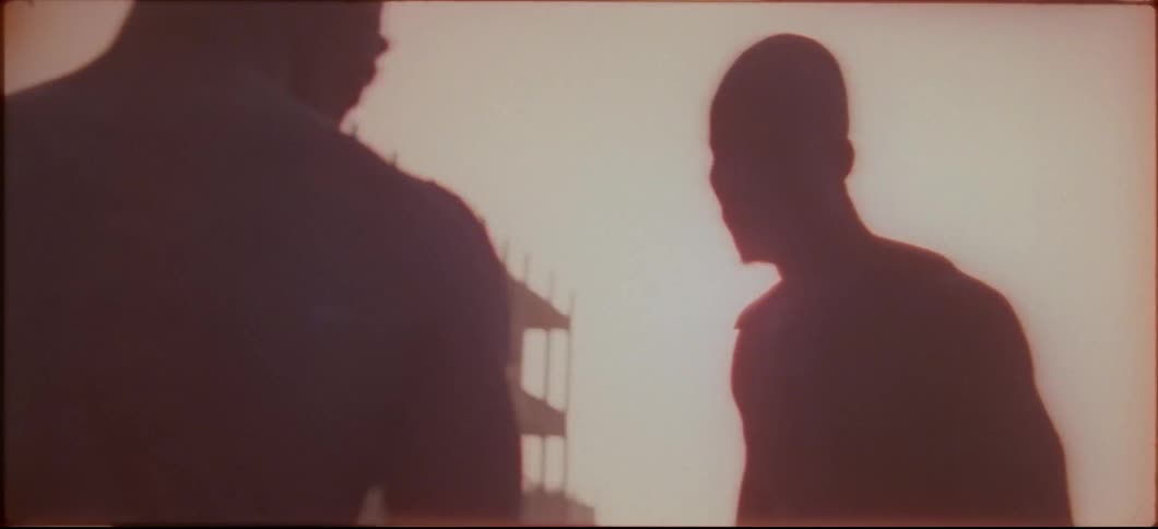 Two men bow and begin to wrestle