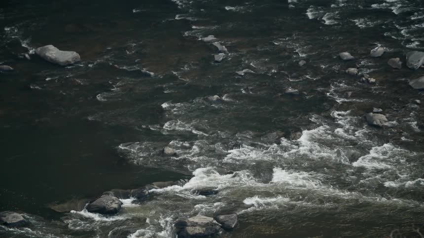 Water flows over rocks in a river