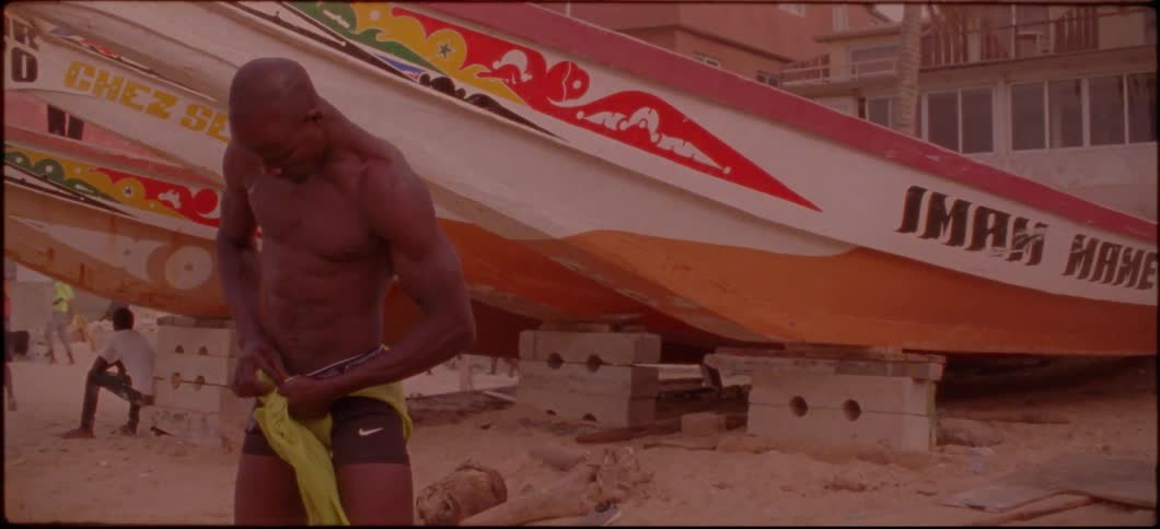 A man is tying a green piece of fabric around his waist