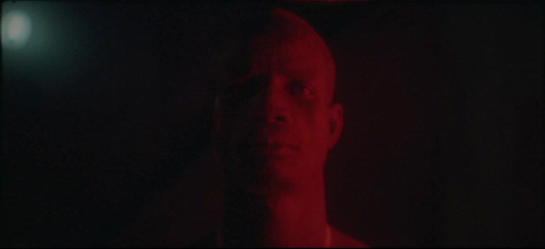 Man's face illuminated by red light