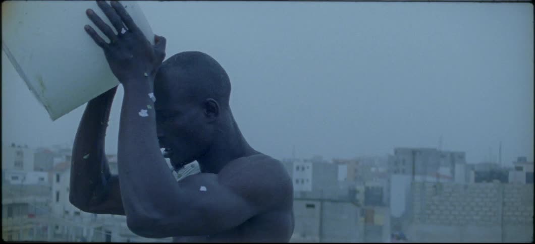 A man pours a bucket of water over his head