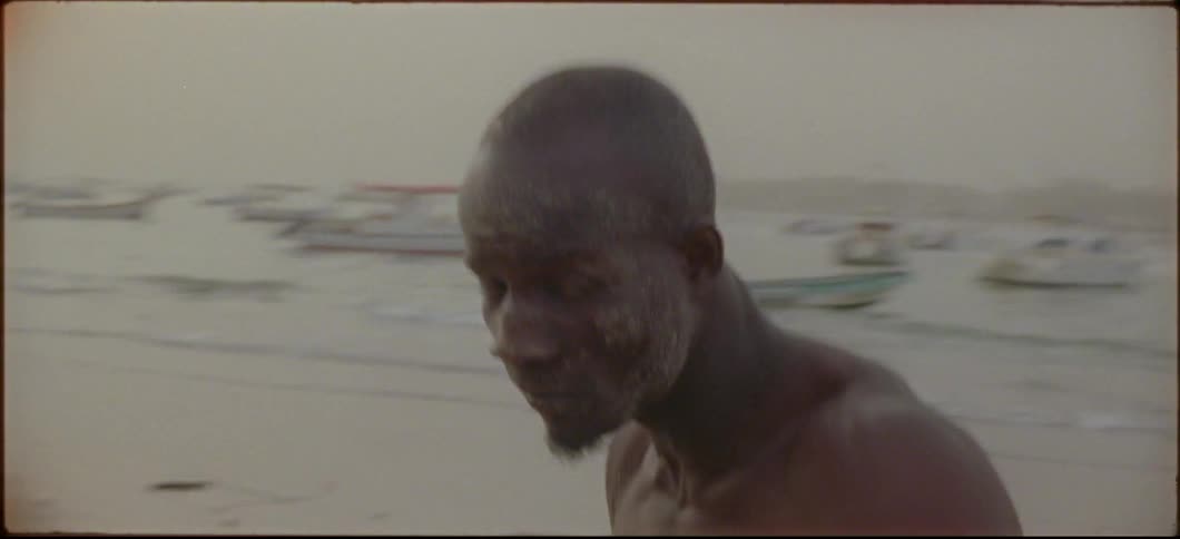 A shirtless man punches the air