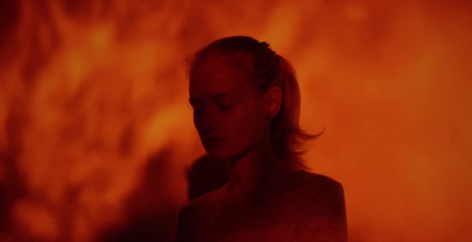 A woman standing in front of a video for fire