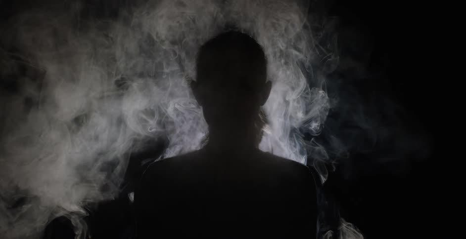 Person standing and facing smoke that's rising