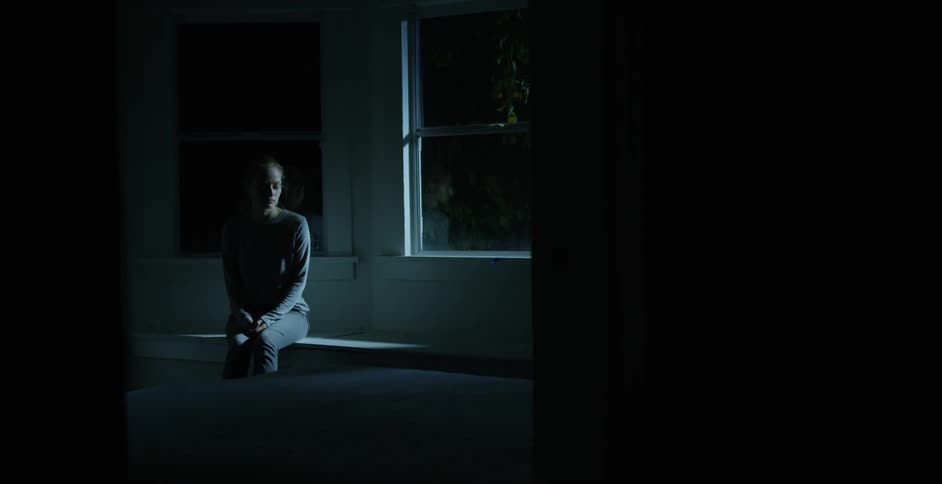 A person sitting next to a window