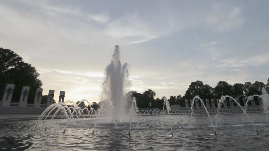 Large fountain with water spraying up on a cloudy day