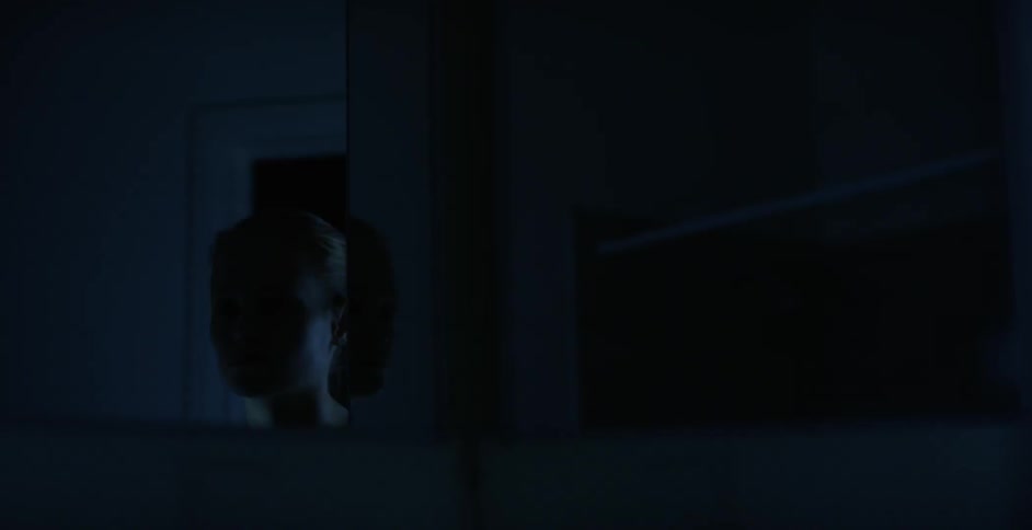A woman standing inside a dark building