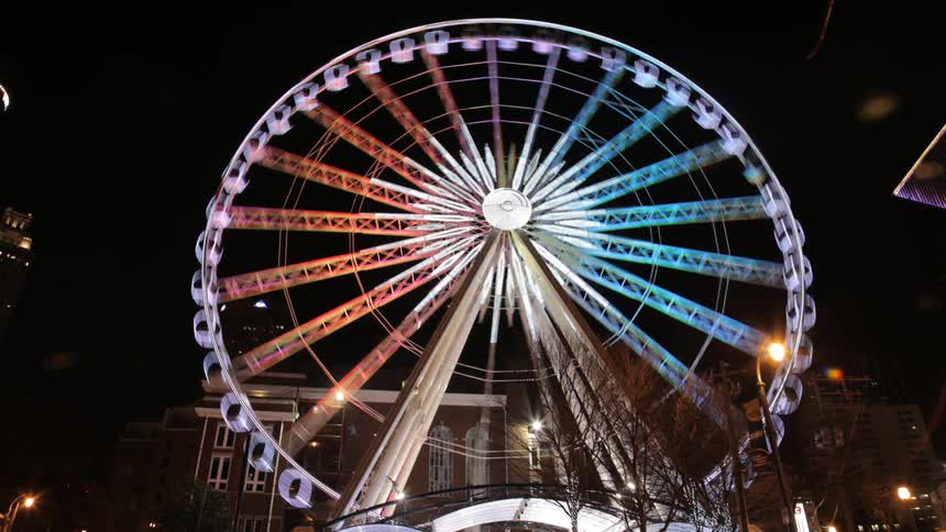 Time lapse shot of a ferris wheel turning at night