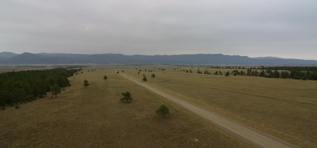 A dirt road runs through the countryside