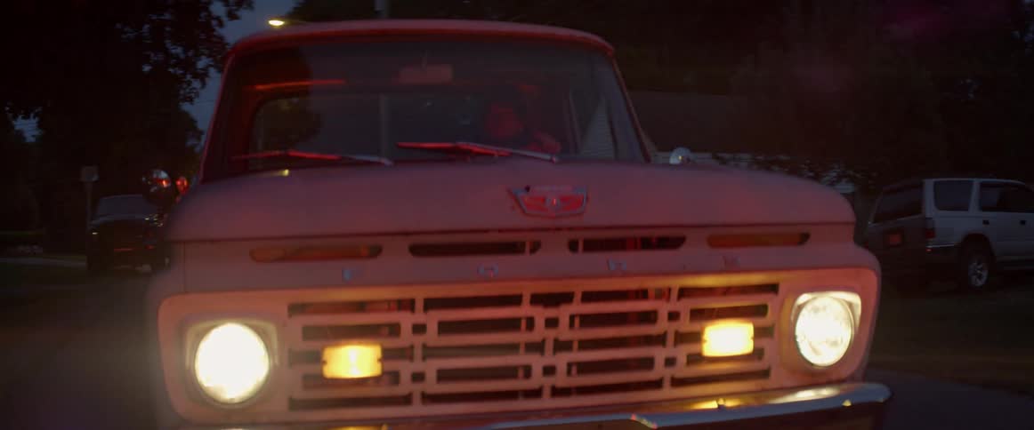 A man driving a truck turns on his blinkers
