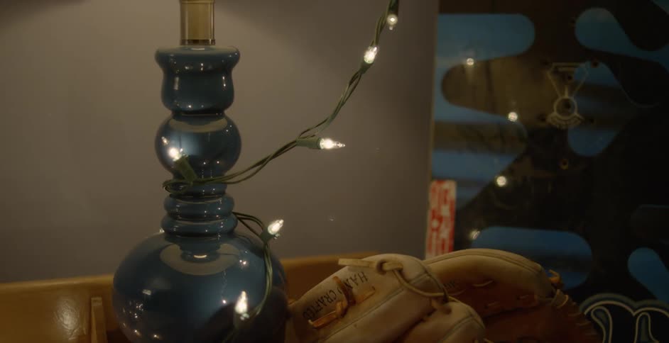 A lamp with Christmas lights around it is turned on