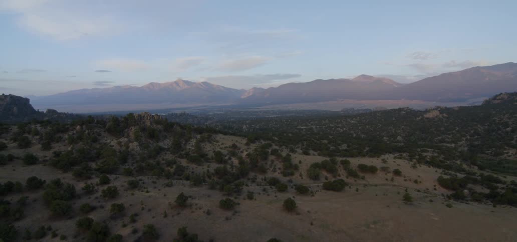 A mountainscape is shown at sunset