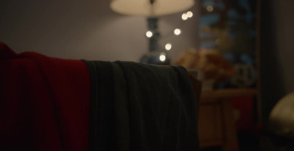 Clothes are sitting on a chair in someone's bedroom