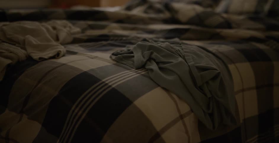 Clothes are spread out on a bed