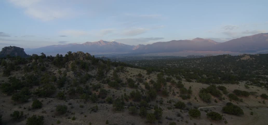 A mountainscape is shown at sunset