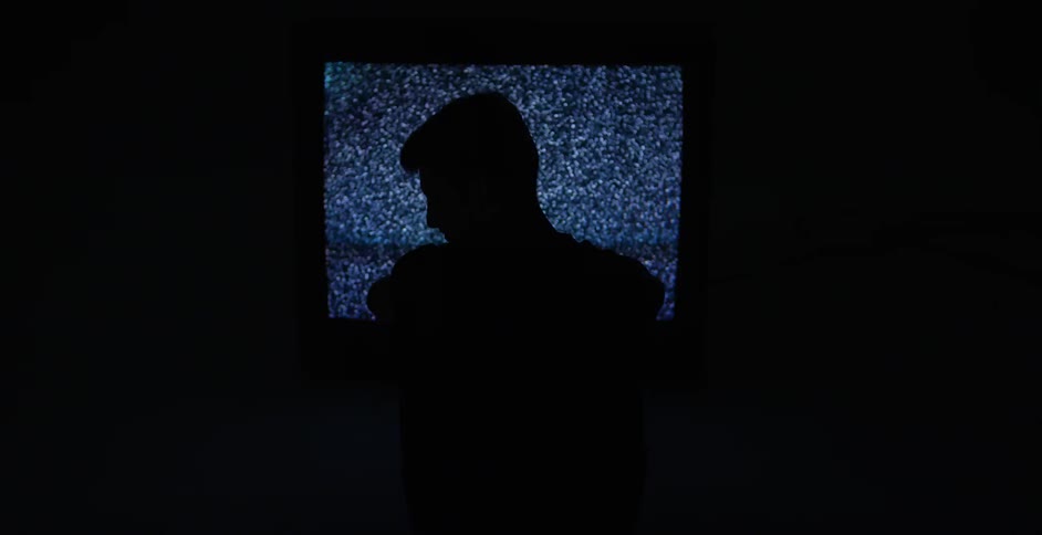A person watching static on a tv