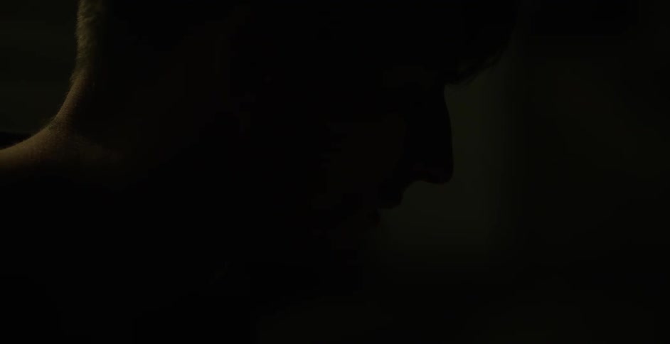 A man smoking a cigarette and exhaling