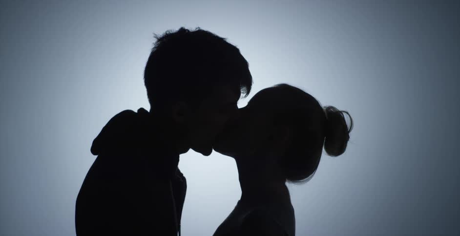 Man and a woman look at each other before kissing