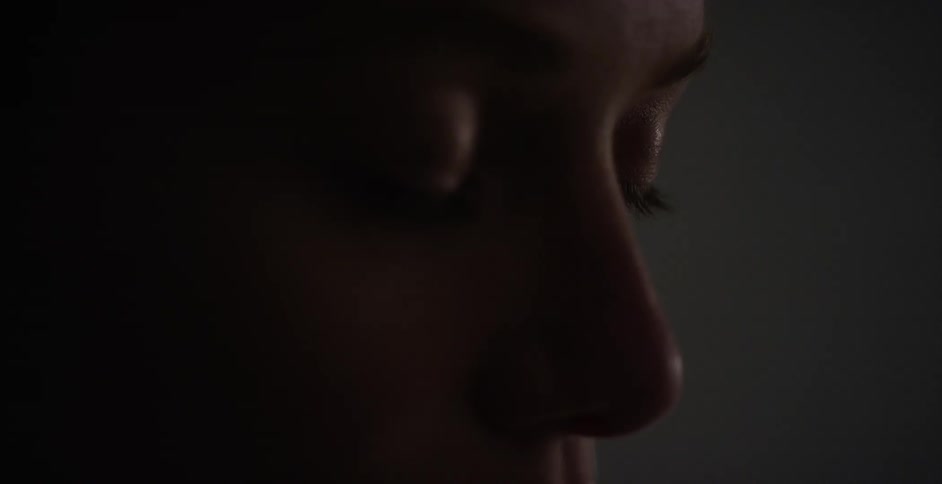 Close up view of a young person's face while in a dark room