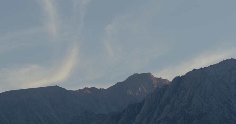 A mountain range in the distance at sunset