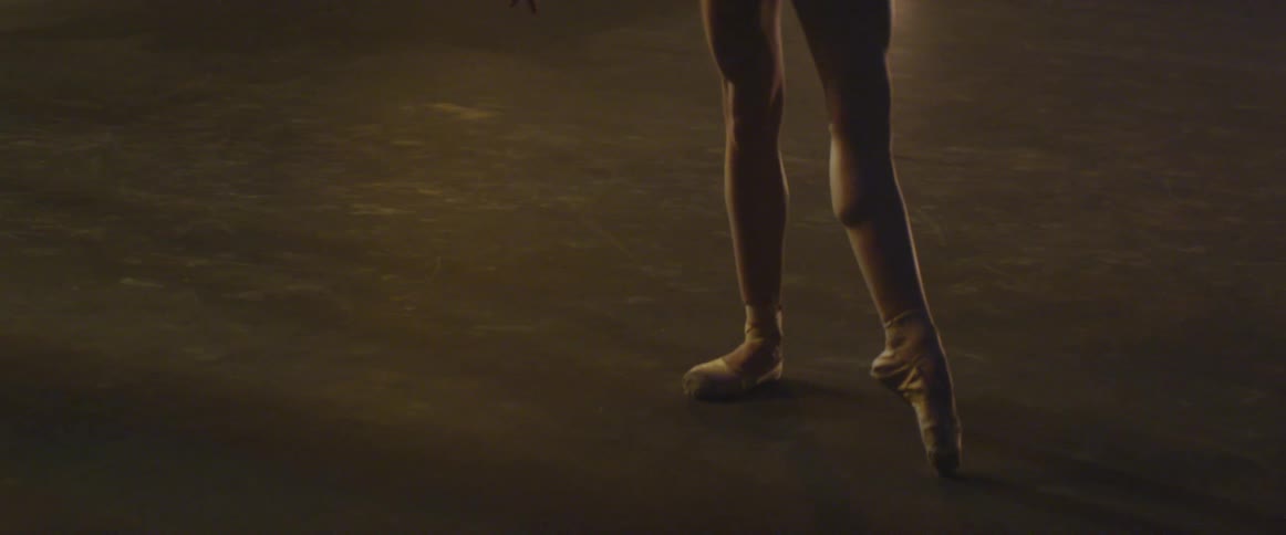 A dancer stretches on stage