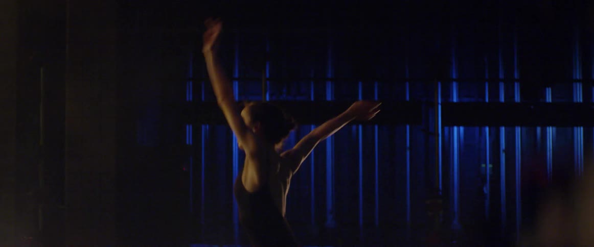 A girl is performing ballet dance on stage