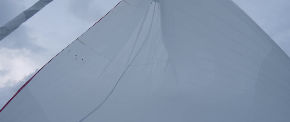 A sail is blowing loose in the wind
