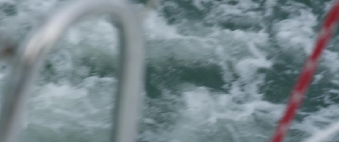 Ocean water splashes and foams in a boat's wake