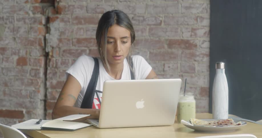 A woman works at a laptop