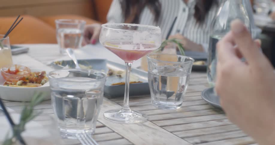 Food and drinks sit on a restaurant patio table