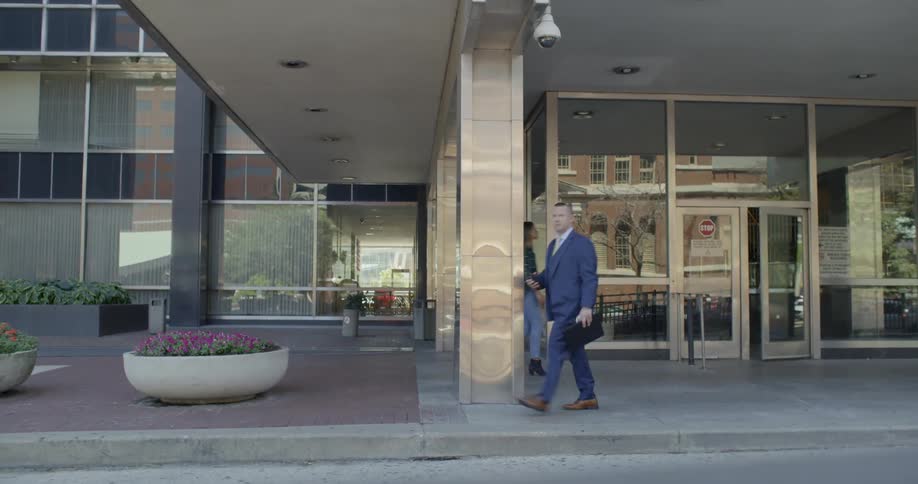 A woman approaches a city building