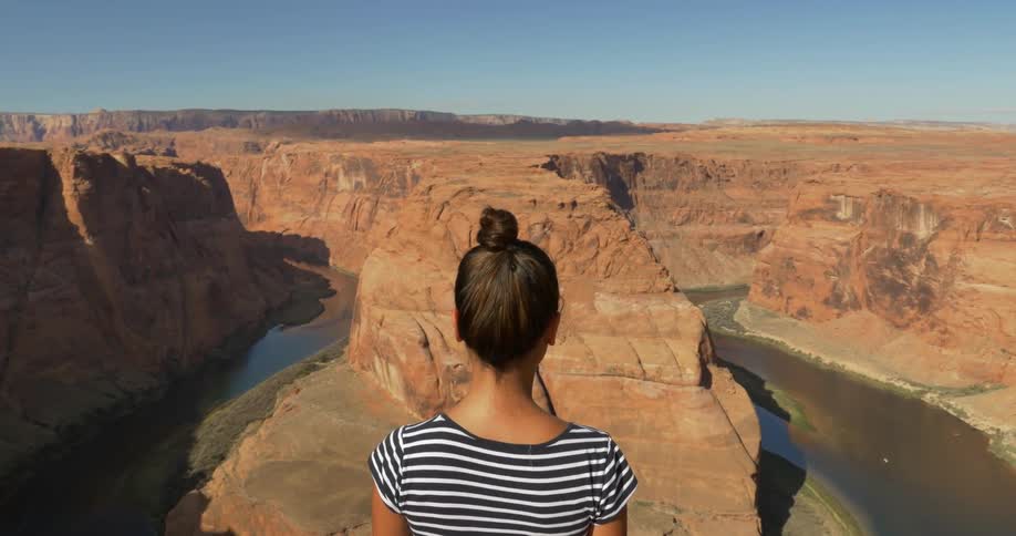 A person standing on a cliff edge