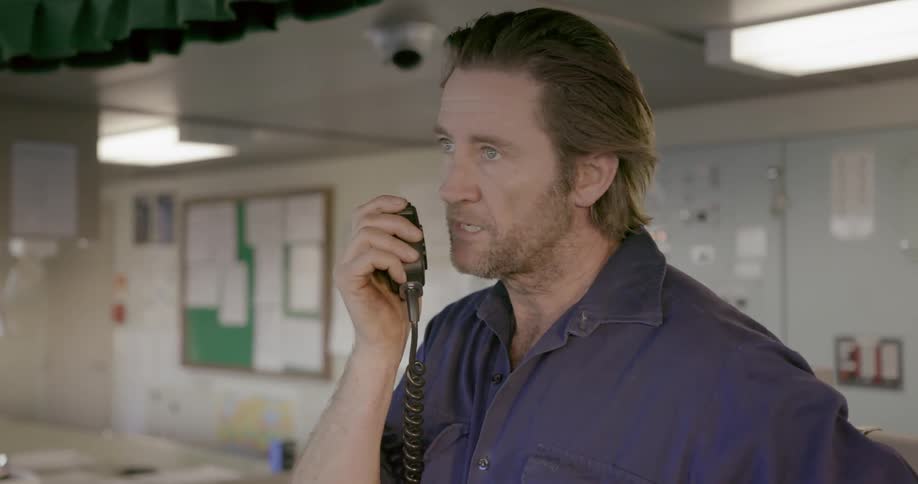 A man talks into a radio then waits for a response