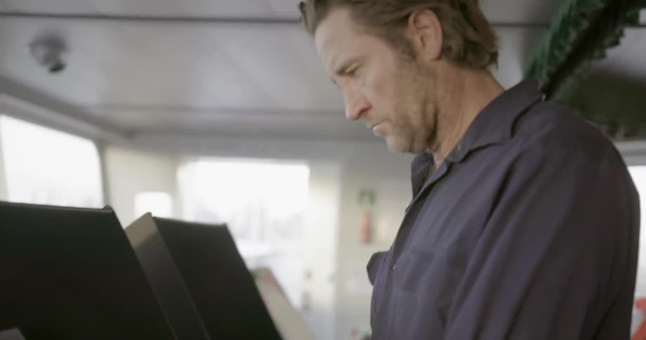 Man stands and works on a computer