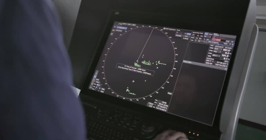 Person looks at a monitor with a dial