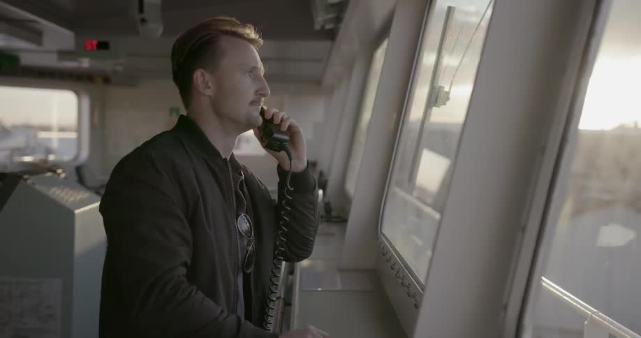 Man talks on a phone near a window