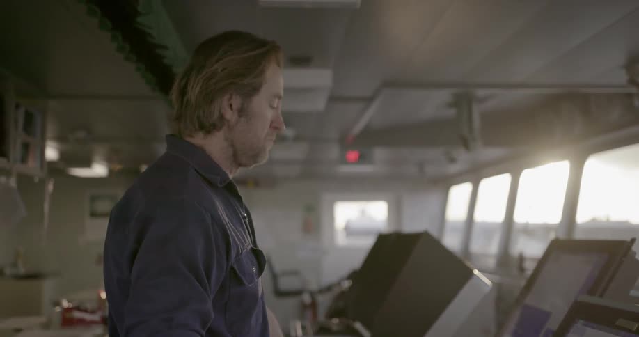 A man is using a computer on a ship