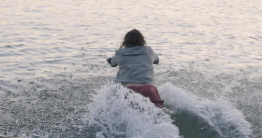 Man runs into a lake and dives in
