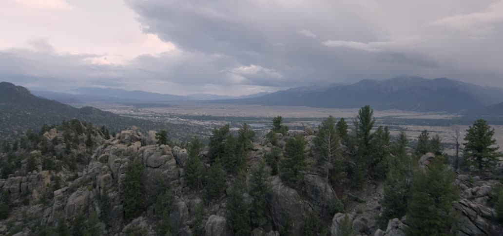 A rocky mountainside is shown at sunrise