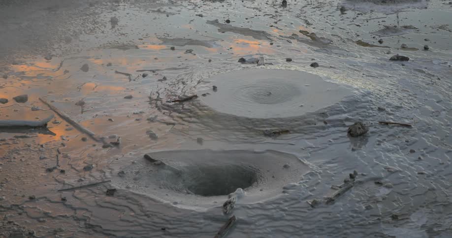 Holes in mud with steam and water coming out